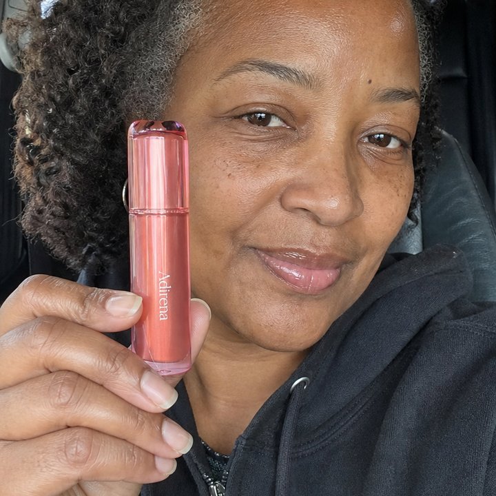Diane holding Adirena Wrinkle-Blur Lip Oil