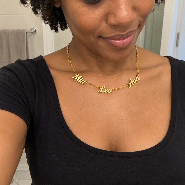 A woman wearing the gold name necklace, everyday phone photo