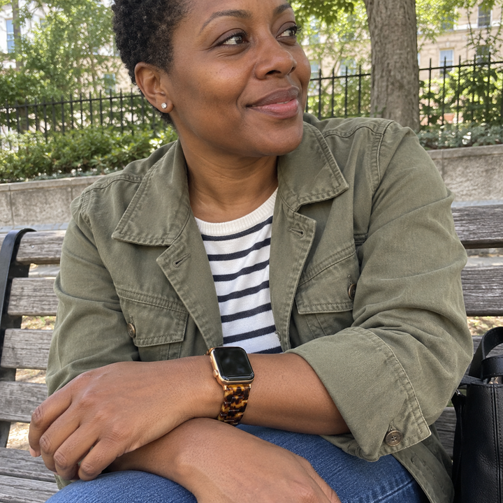 Woman wearing an Adirena resin link watch band in Leopard, sitting outside
