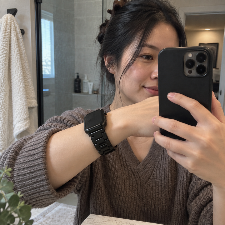 Woman wearing an Adirena resin link watch band in Black, a mirror frame taken at arm's length