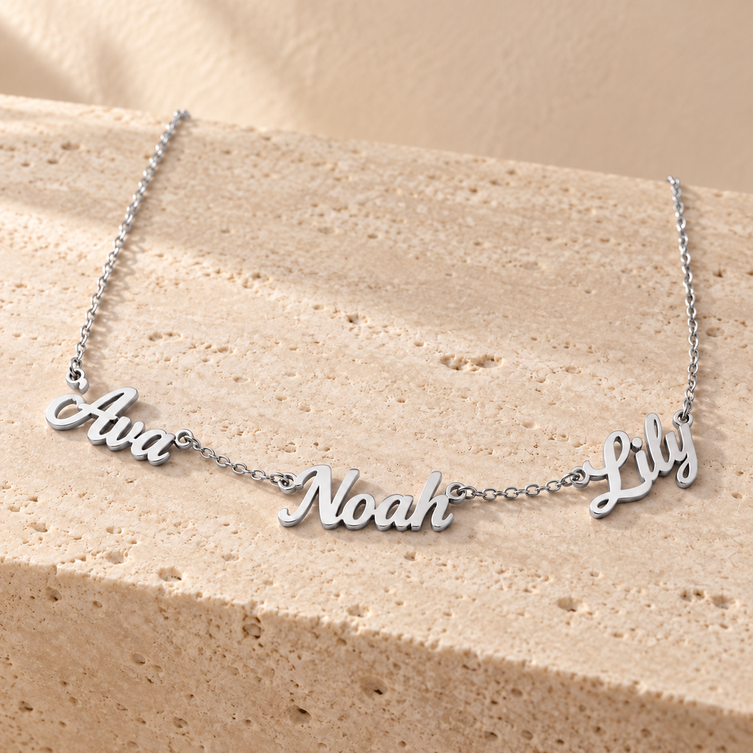 Kindred multi-name necklace in silver with three cut-out script names linked into a fine chain