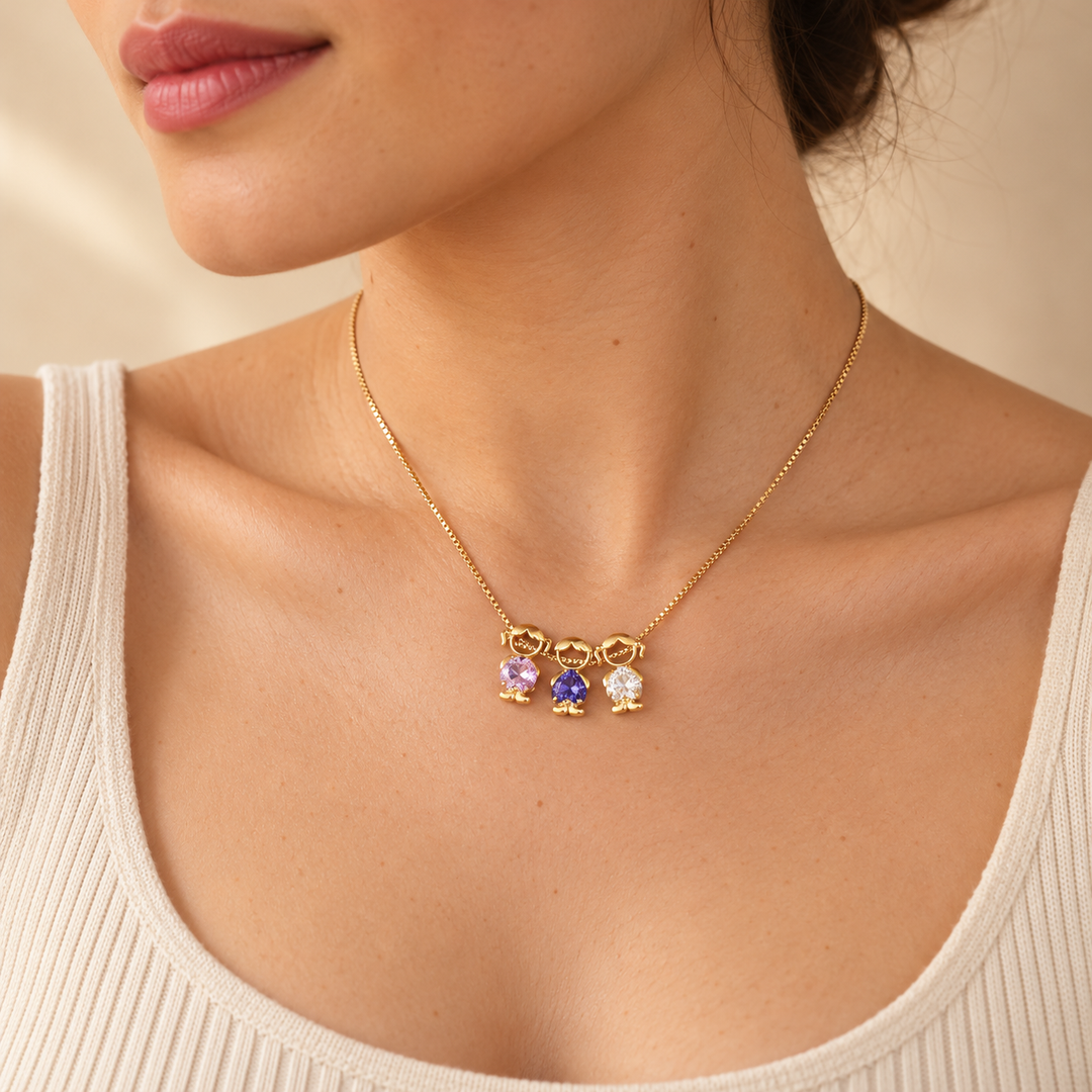 Woman in an ivory ribbed tank wearing the gold-tone necklace, three small charms resting just below her throat