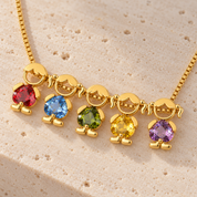 Five boy and girl charms on a gold-tone box chain: bright red, sky blue, olive green, yellow and violet heart-cut stones