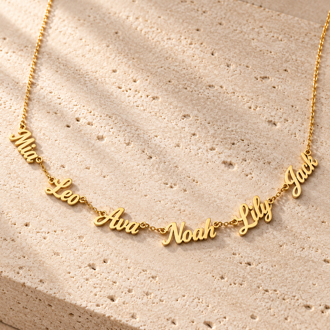 Kindred multi-name necklace in gold carrying six cut-out script names along one fine chain