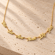 Kindred multi-name necklace in gold carrying six cut-out script names along one fine chain