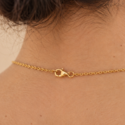 The necklace fastened at the back of the neck with a lobster clasp