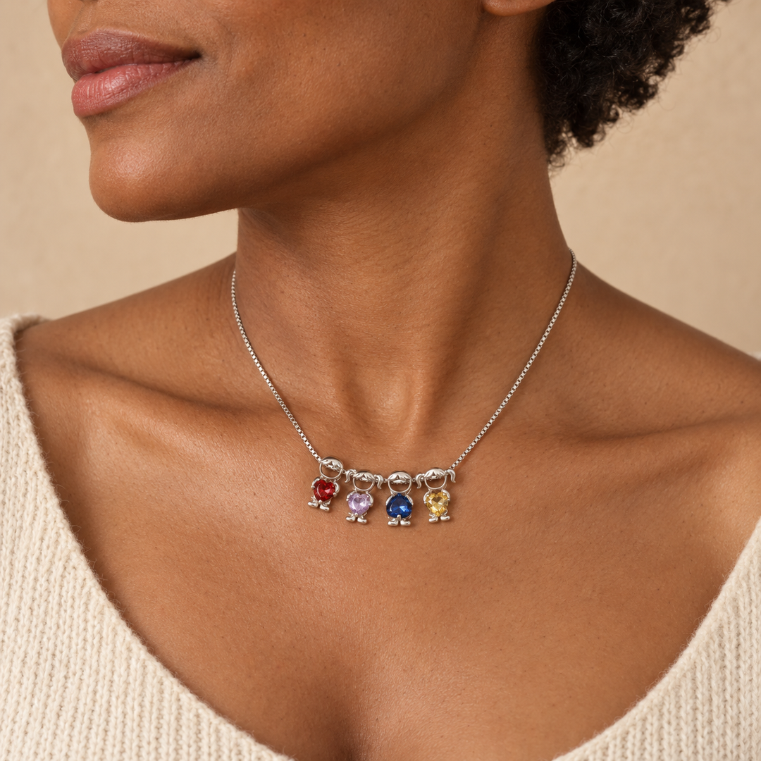Woman in a cream knit wearing the silver-tone necklace with four charms in bright red, pale lavender, royal blue and yellow