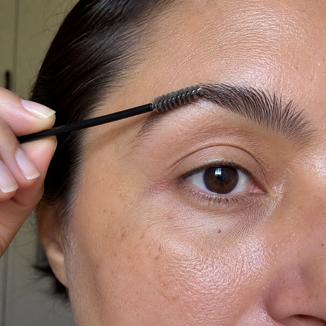 Brushing the brow upward with the spoolie wand