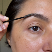 Brushing the brow upward with the spoolie wand