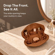 Open Brown Clara with two bottles, a compact and a brush in its flexible interior on a vanity
