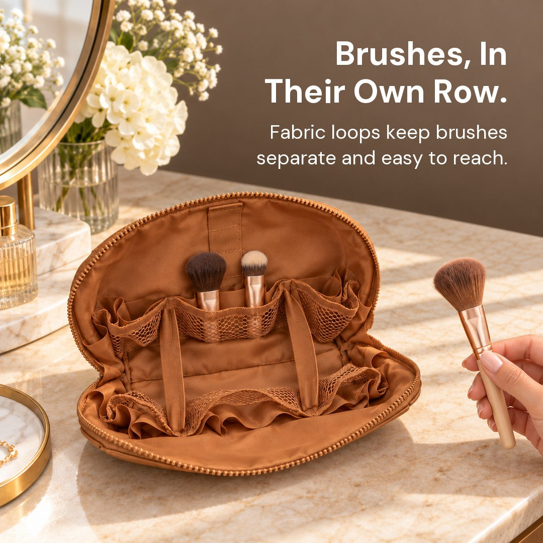 A hand holds a brush above open Brown Clara, with two brushes stored inside