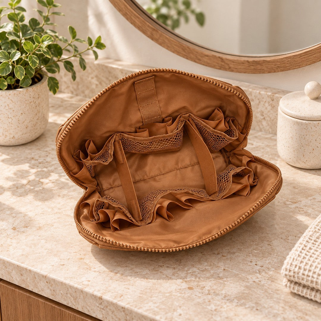 Empty Brown Clara showing its fold-down panel, fabric strips and gathered mesh pockets