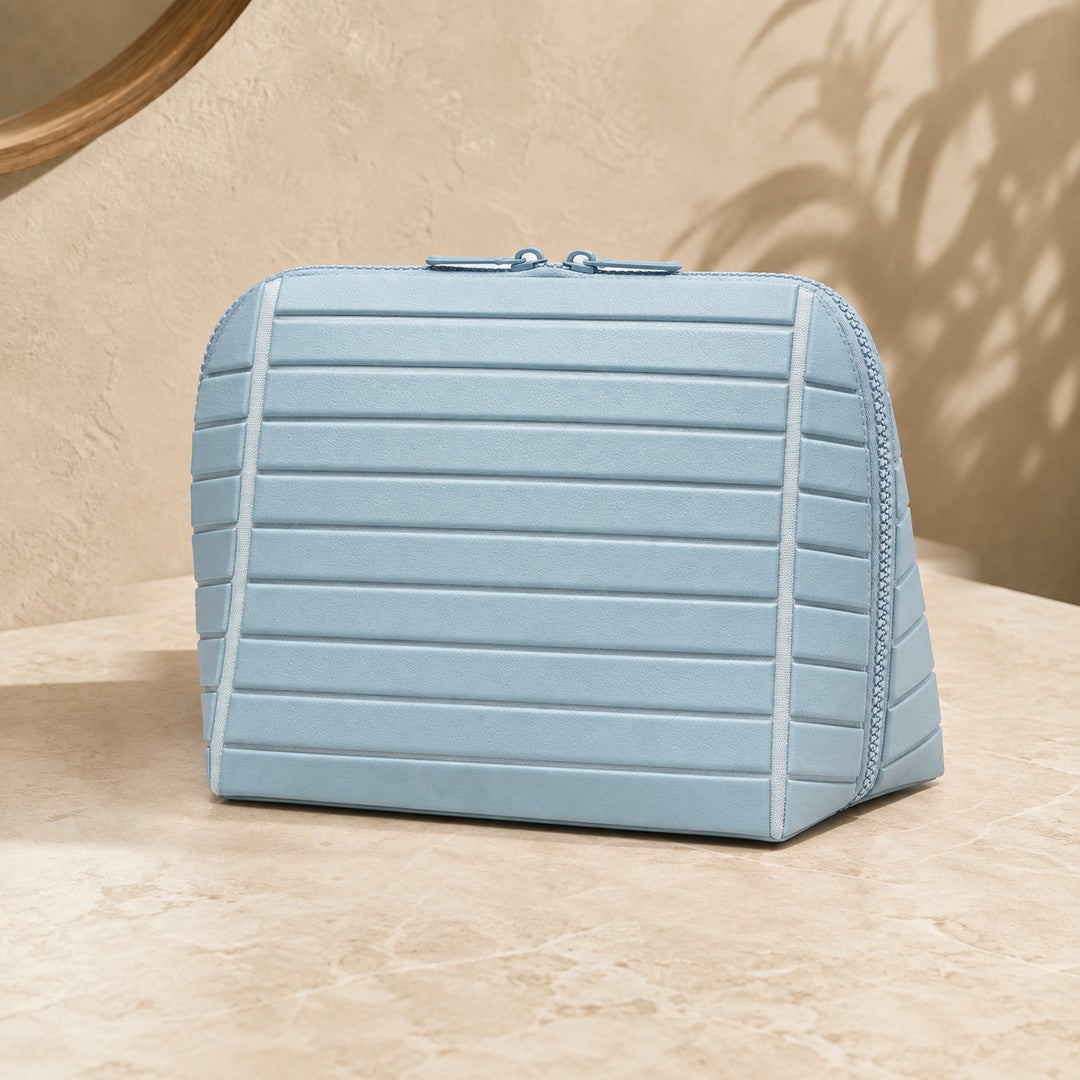 Closed light blue Clara makeup bag viewed from the front