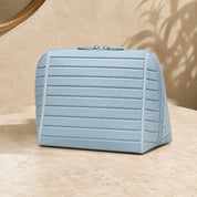 Closed light blue Clara makeup bag viewed from the front