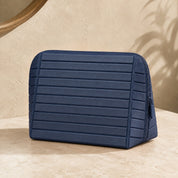 Closed navy Clara makeup bag viewed from the front