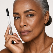 Model holding the Hair-Stroke Brow Pen with naturally full brows