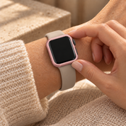 Fingers touching the seated Halo pink case frame on a watch
