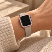 Halo pink case frame on a watch worn on the wrist with a plain neutral band