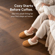Chestnut Haven slippers worn with both feet on a wood floor while holding a duvet at the bedside.