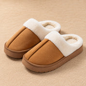 Chestnut Haven slippers with a raised centre seam, white plush collar and low brown sole.