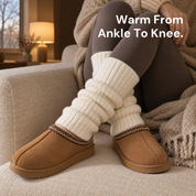 Adirena Sunday Leg Warmers in Cream, pulled up below the knee, curled up on a sofa in Adirena Sunday slippers.
