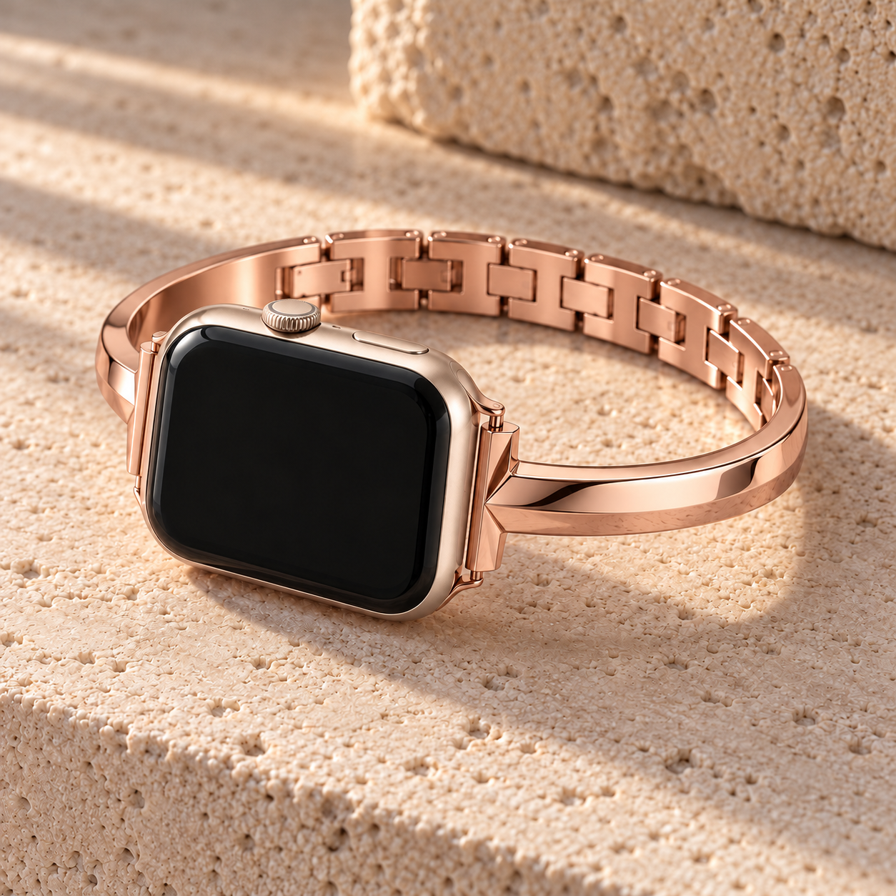 Blusharc rose gold watch band on a watch, resting on pale stone