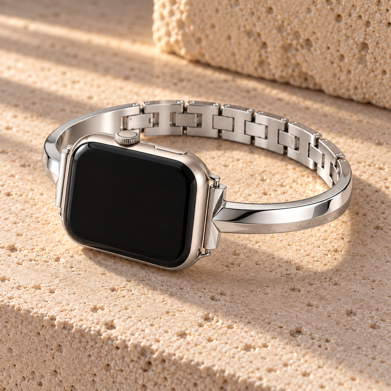Moonrill silver watch band on a watch, resting on pale stone