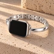 Moonrill silver watch band on a watch, resting on pale stone