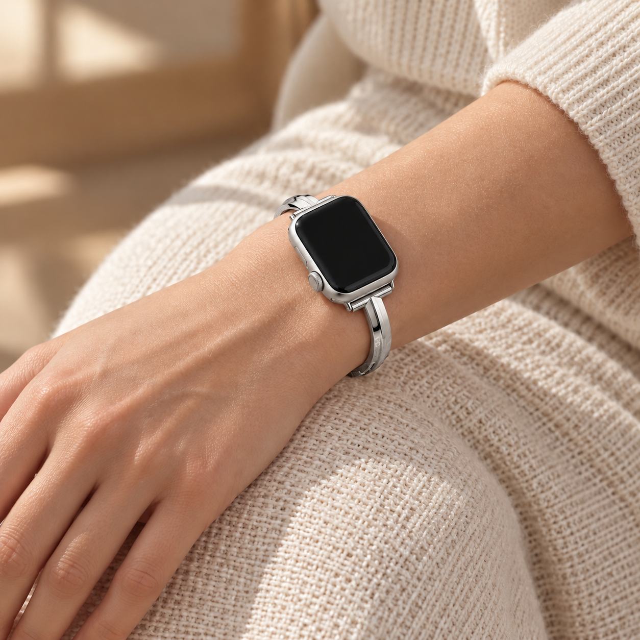 Moonrill silver watch band worn on a left wrist resting on a knee