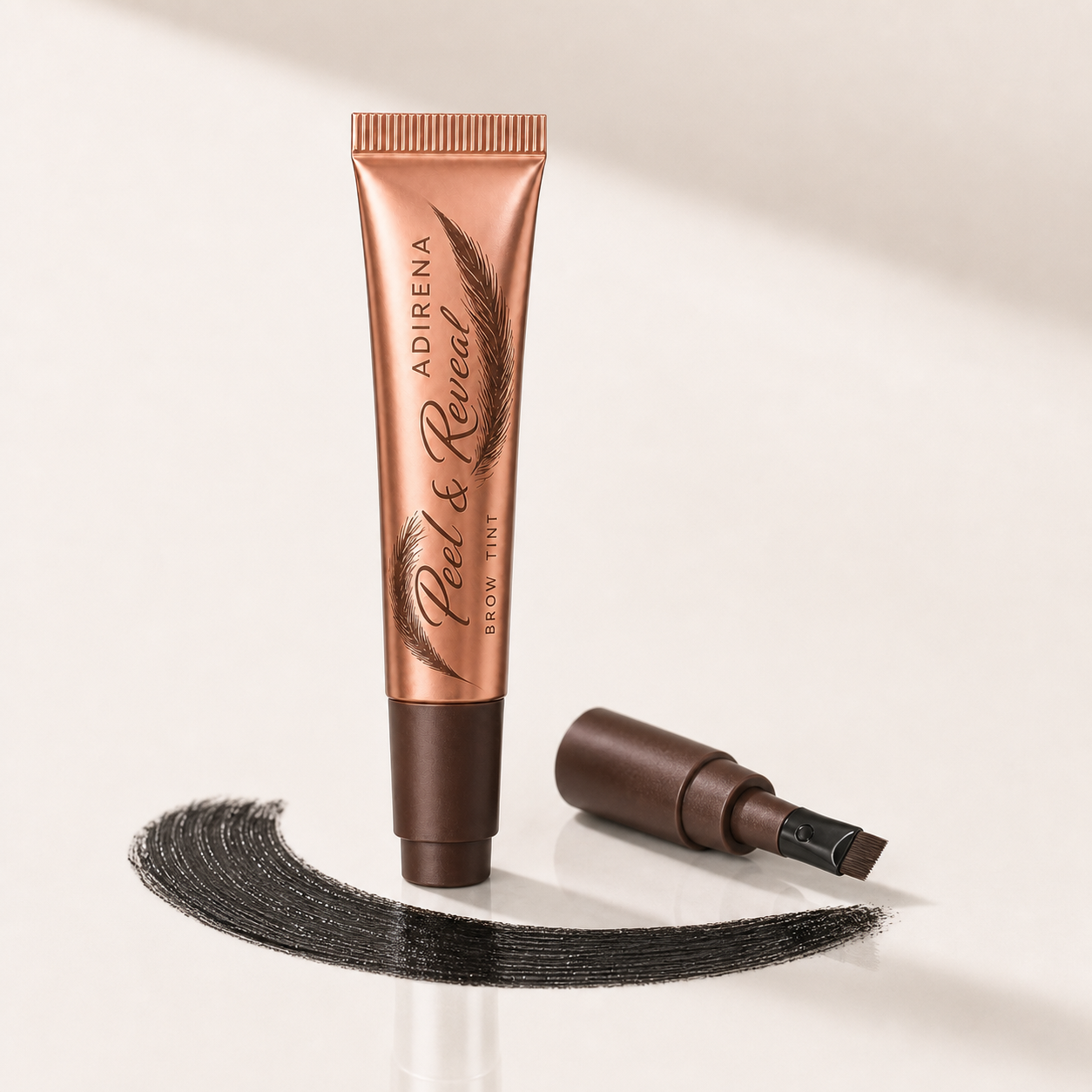 Adirena Peel & Reveal Brow Tint tube and dual-ended applicator with black gel swatch, hero shot