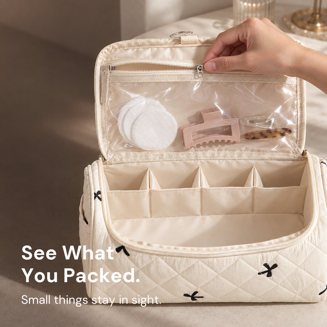 A hand drawing the zip of the clear pocket inside the lid of an open cream quilted hair-tool case