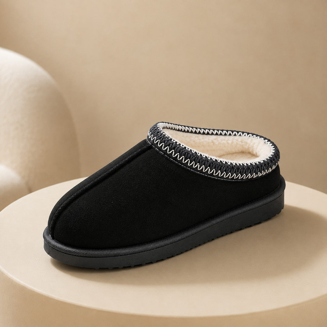 One black slipper on a warm plaster plinth
