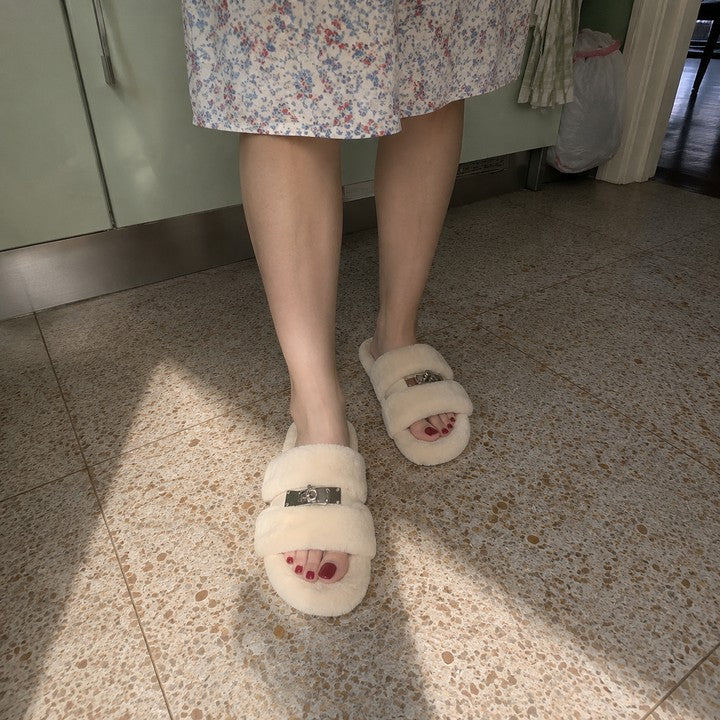 A woman looking down at her cream fur slippers on a kitchen floor