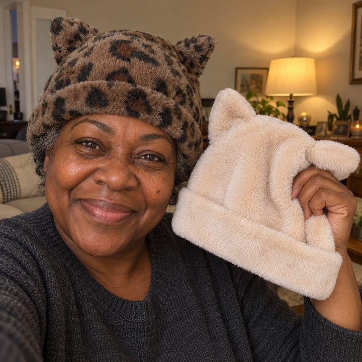 Illustrative selfie of a woman wearing a Leopard Cleo cat ear hat and holding up an Apricot one for her daughter.