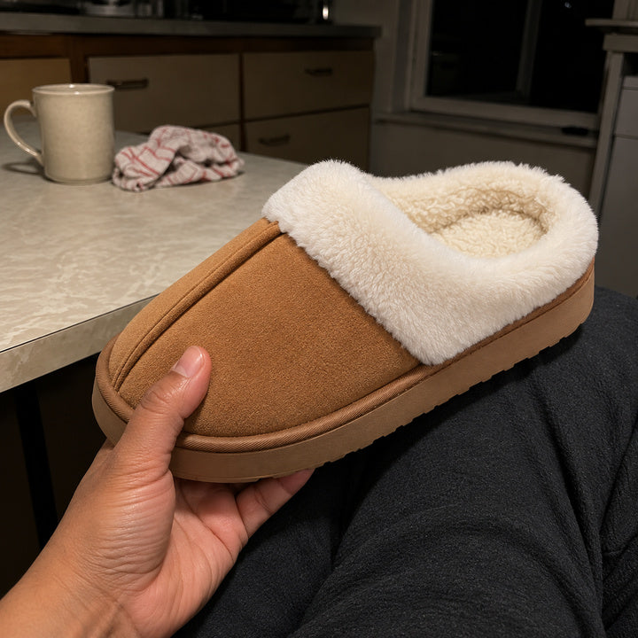 One Chestnut Haven slipper supported in a hand above the person's lap.
