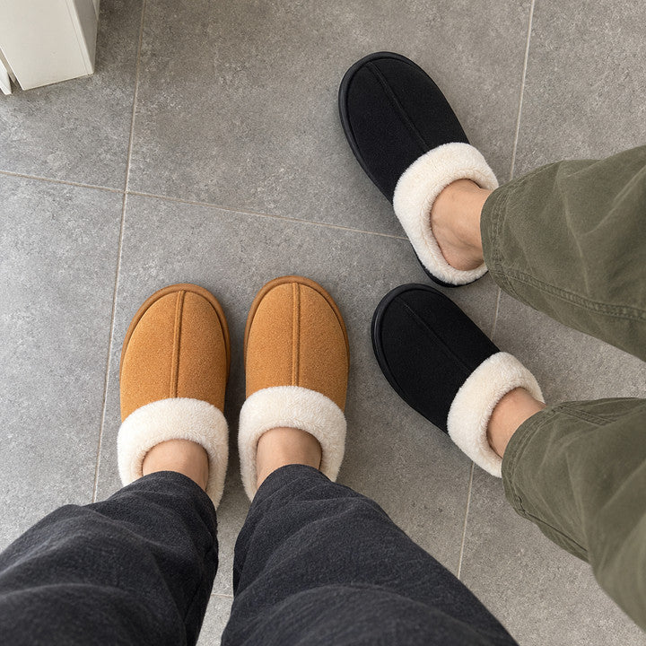 Two people wearing Chestnut and Black Haven slippers together, photographed looking down at their four feet.