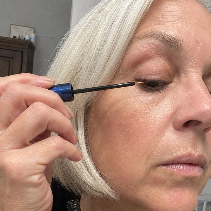 Olivia holding Adirena Adirena Brow & Lash Serum