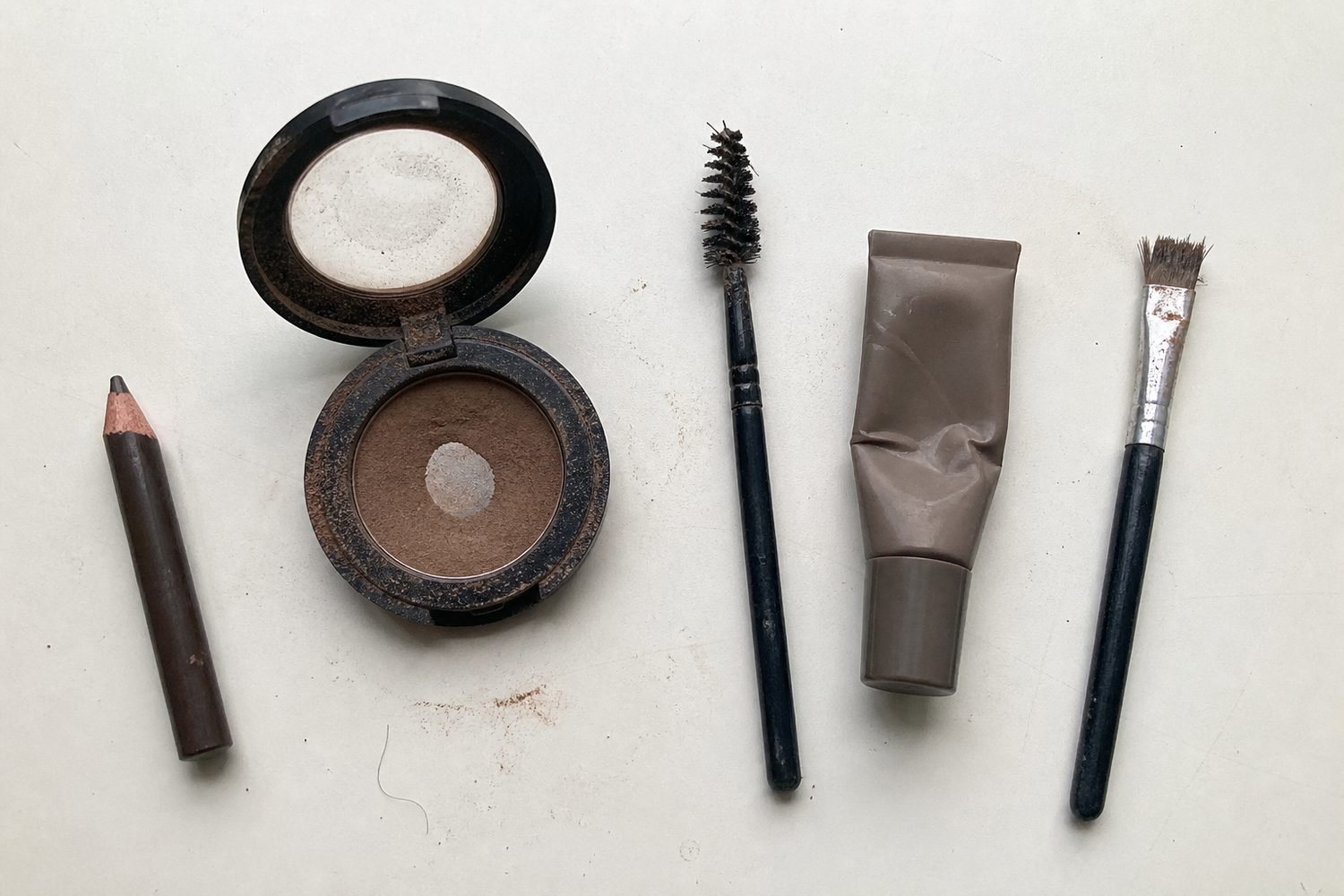 Worn brow tools on a countertop