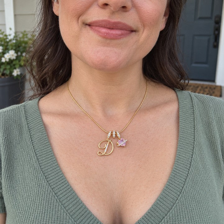 A woman wearing the gold Cherie initial necklace, everyday phone photo