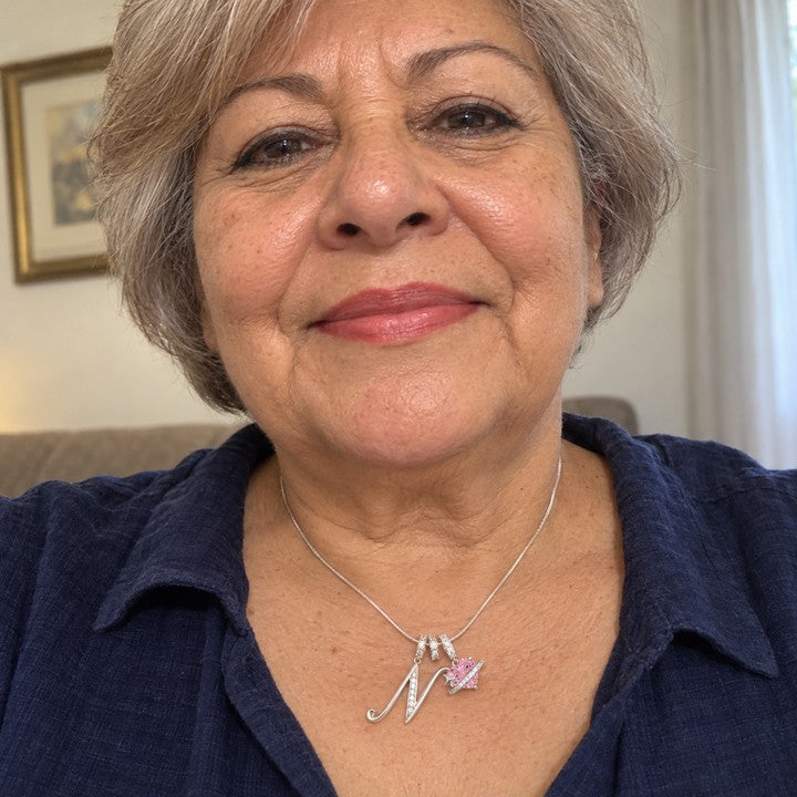 A woman's selfie wearing the silver Cherie initial necklace, everyday phone photo