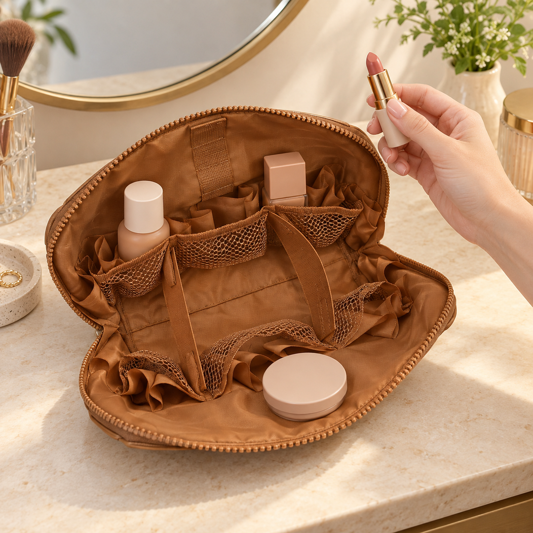 Open Brown Clara with everyday cosmetics visible as a hand lifts a small lipstick beside the bag