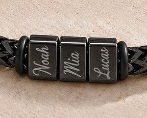 Noah, Mia and Lucas engraved on the black bracelet's blocks