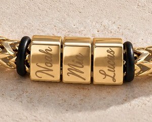 Noah, Mia and Lucas engraved on the gold bracelet's blocks