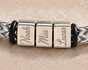 Noah, Mia and Lucas engraved on the silver bracelet's blocks
