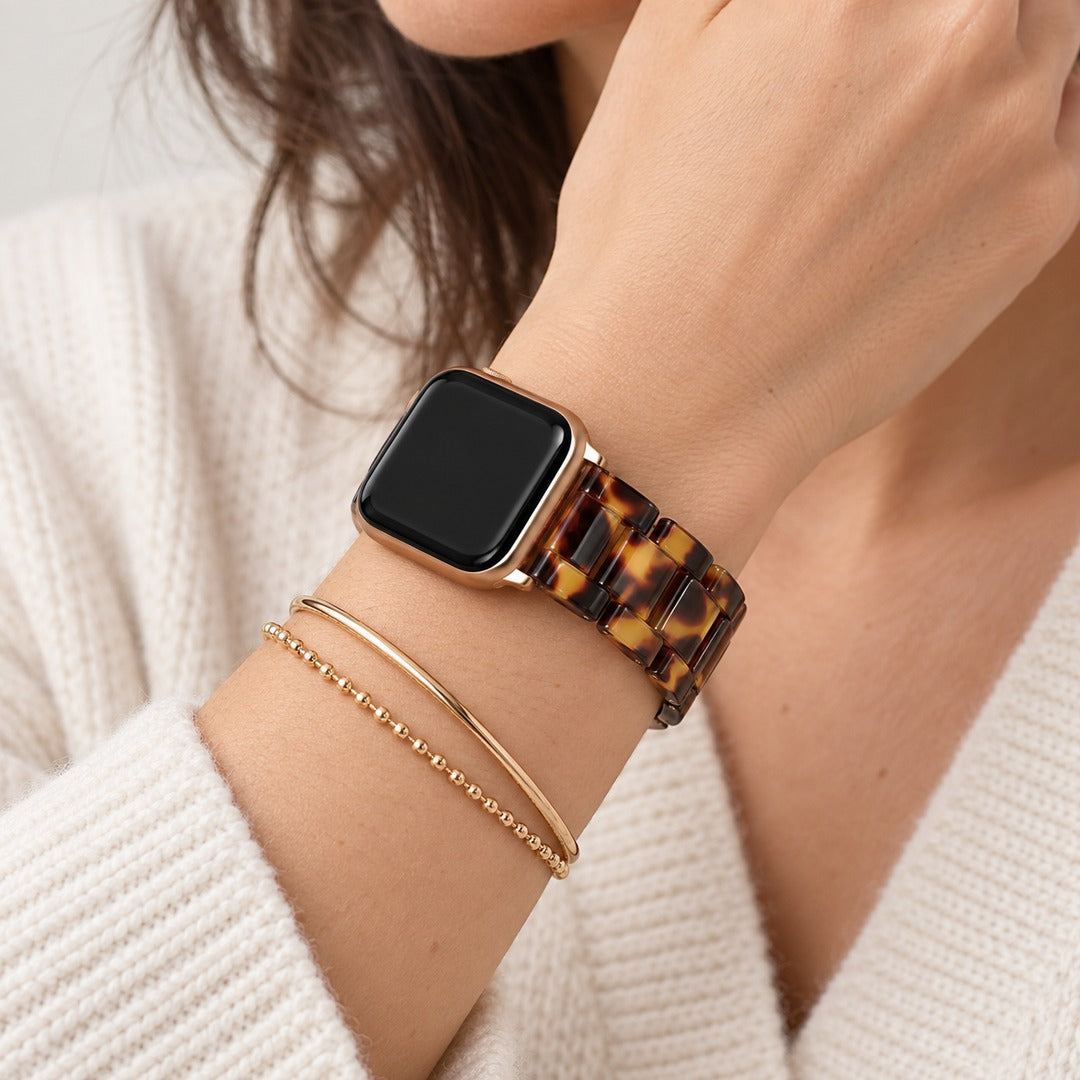 Adirena tortoiseshell link watch band worn and stacked with fine bracelets